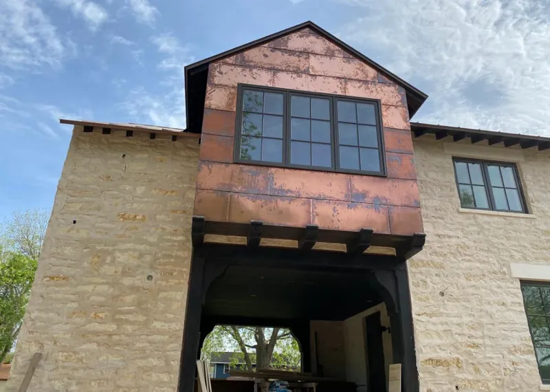 Copper metal panel facade on a stone building for Metal Roof Coating in Centerton