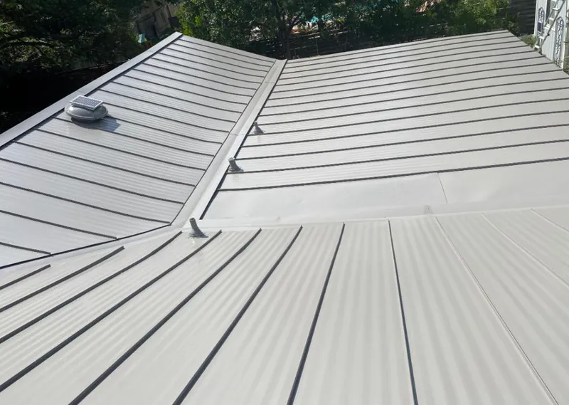 Solar attic fan installed on a metal roof for Roof Ventilation in Centerton